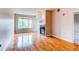 Living room shows hardwood flooring, large window, fireplace, and neutral walls at 2700 E Cherry Creek S Dr # 302, Denver, CO 80209