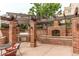 Outdoor kitchen with built-in grill and fireplace in a brick structure for outdoor dining at 2700 E Cherry Creek S Dr # 302, Denver, CO 80209