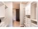 Spacious walk-in closet with custom built-ins and shelving with bathroom in view at 2700 E Cherry Creek S Dr # 302, Denver, CO 80209