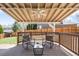 Covered back deck with ceiling fan perfect for entertaining, complete with chairs and table at 5174 W 123Rd Pl, Broomfield, CO 80020