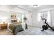 Bright basement bedroom with an exercise bike, wood floors, and modern lighting at 5174 W 123Rd Pl, Broomfield, CO 80020
