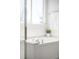 Close-up of soaking tub with tiled surround and bright window, next to glass enclosed shower at 5174 W 123Rd Pl, Broomfield, CO 80020