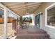 Covered patio with ceiling fan and furniture overlooking the backyard and the wood fence at 5174 W 123Rd Pl, Broomfield, CO 80020