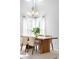 Bright dining room with a modern chandelier, bay window, and wood table at 5174 W 123Rd Pl, Broomfield, CO 80020