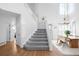 Bright foyer with staircase, hardwood floors, and dining area with modern lighting at 5174 W 123Rd Pl, Broomfield, CO 80020