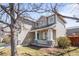 Charming home featuring a cozy front porch with stone accents and a manicured lawn at 5174 W 123Rd Pl, Broomfield, CO 80020