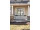 Inviting front porch with decorative lattice, stone accents, and outdoor seating at 5174 W 123Rd Pl, Broomfield, CO 80020
