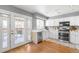 Modern kitchen with white cabinets, stainless steel appliances, and access to the back deck at 5174 W 123Rd Pl, Broomfield, CO 80020