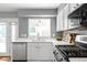 A sink and countertop with white cabinets in a well-lit kitchen area at 5174 W 123Rd Pl, Broomfield, CO 80020
