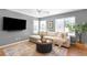 Comfortable living room featuring a TV, white couch, and plenty of natural light at 5174 W 123Rd Pl, Broomfield, CO 80020