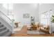 Airy living room with vaulted ceilings, hardwood floors, and stylish furniture at 5174 W 123Rd Pl, Broomfield, CO 80020