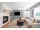 Cozy living room with fireplace, mounted TV, and a comfortable white couch at 5174 W 123Rd Pl, Broomfield, CO 80020