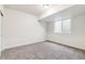 Finished basement bedroom features a neutral carpet, a window, and closet space at 15448 Kearney St, Brighton, CO 80602