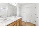 Bright bathroom showcasing a double vanity, quartz counters, and wood-look floors at 15448 Kearney St, Thornton, CO 80602