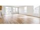 Bright living room area featuring wood-look floors and large sliding door to the outside at 15448 Kearney St, Thornton, CO 80602