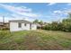 Wide backyard view with grass, fence, and the back of a white house underneath sunny skies at 3715 N Jackson St, Denver, CO 80205