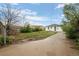Exterior view of a backyard featuring a long driveway and a partially fenced yard at 3715 N Jackson St, Denver, CO 80205