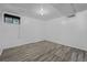 Finished basement room showcasing vinyl flooring and a partially finished ceiling with light at 3715 N Jackson St, Denver, CO 80205