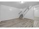 Finished basement with vinyl flooring, stairs to upper floor, and ample room for storage at 3715 N Jackson St, Denver, CO 80205