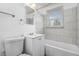 Modern bathroom with white vanity, toilet and tub with shower at 3715 N Jackson St, Denver, CO 80205