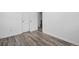 A bright bedroom featuring wood-look flooring and double closets providing ample storage at 3715 N Jackson St, Denver, CO 80205