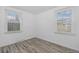 Bedroom with two windows, light walls, and wood-look flooring at 3715 N Jackson St, Denver, CO 80205