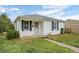 Charming home featuring white exterior and well-maintained lawn at 3715 N Jackson St, Denver, CO 80205