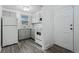 Efficient kitchen with tile backsplash and white appliances at 3715 N Jackson St, Denver, CO 80205
