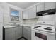 Well-lit kitchen features grey cabinets, tile backsplash, and laminate countertops at 3715 N Jackson St, Denver, CO 80205