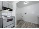 Bright kitchen boasts wood-look floors and white walls at 3715 N Jackson St, Denver, CO 80205