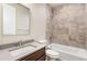 Bright bathroom featuring a tub-shower and a sleek single-sink vanity at 308 Josef Cir, Fort Lupton, CO 80621