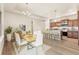Bright dining area with modern chandelier lighting, a table for six, and an island bar at 308 Josef Cir, Fort Lupton, CO 80621
