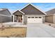 Charming home featuring stone accents, a two-car garage, and a well-maintained front yard at 308 Josef Cir, Fort Lupton, CO 80621