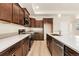 Well-equipped kitchen featuring stainless steel appliances, dark wood cabinets, and a spacious island at 308 Josef Cir, Fort Lupton, CO 80621