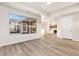 Spacious room with hardwood floors, a bright window, and open access to the rest of the house at 308 Josef Cir, Fort Lupton, CO 80621