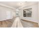 Open-concept living room with hardwood flooring and large windows, seamlessly connected to other areas at 308 Josef Cir, Fort Lupton, CO 80621