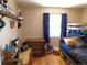 Bedroom featuring a bunkbed, hardwood flooring, a window with curtains and built in shelving at 9180 Spruce Mountain Rd, Larkspur, CO 80118