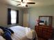 Serene bedroom featuring natural light, a ceiling fan, and a dresser with a decorative mirror at 9180 Spruce Mountain Rd, Larkspur, CO 80118