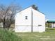 Exterior of home featuring minimalist architecture, single window, and a rustic door at 9180 Spruce Mountain Rd, Larkspur, CO 80118
