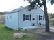 Charming home featuring a well-maintained lawn, attractive shutters, and a serene, tree-lined backdrop at 9180 Spruce Mountain Rd, Larkspur, CO 80118