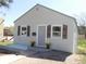 Inviting single-story home boasts a manicured front yard with charming shutters and potted plants at 9180 Spruce Mountain Rd, Larkspur, CO 80118