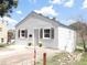 Charming home exterior with decorative shutters, freshly painted white plaster and inviting curb appeal at 9180 Spruce Mountain Rd, Larkspur, CO 80118