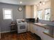 Charming kitchen with white cabinetry, vintage appliances, and abundant natural light from the window at 9180 Spruce Mountain Rd, Larkspur, CO 80118