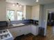 Bright kitchen with white cabinets, double sink, and ample counter space for cooking and meal preparation at 9180 Spruce Mountain Rd, Larkspur, CO 80118