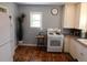 Functional kitchen shows a refrigerator and stove with white cabinets and natural light at 9180 Spruce Mountain Rd, Larkspur, CO 80118
