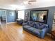 Inviting living room boasting hardwood floors, neutral walls, ceiling fan, and a comfortable sofa with a striking patterned throw at 9180 Spruce Mountain Rd, Larkspur, CO 80118