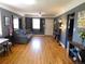 Inviting living room boasting hardwood floors, neutral walls, and a ceiling fan at 9180 Spruce Mountain Rd, Larkspur, CO 80118