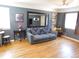 Inviting living room boasting hardwood floors, neutral walls, and a comfortable sofa with a striking patterned throw at 9180 Spruce Mountain Rd, Larkspur, CO 80118