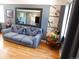 Inviting living room boasting hardwood floors, neutral walls, and a comfortable sofa with a striking patterned throw at 9180 Spruce Mountain Rd, Larkspur, CO 80118
