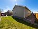 The backyard shows green grass, a fence, gravel, and a swing set at 541 Park Blvd, Brighton, CO 80603